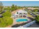 Backyard with a sparkling pool, covered patio, and lush green lawn at 2438 N Forest Cir, Mesa, AZ 85203