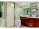 This bathroom offers a double sink vanity, walk-in shower, and tile flooring at 2438 N Forest Cir, Mesa, AZ 85203