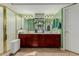 This bathroom offers a double sink vanity, walk-in shower, and tile flooring at 2438 N Forest Cir, Mesa, AZ 85203