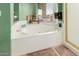 A luxurious bathroom provides a large soaking tub, walk-in shower, and tile flooring at 2438 N Forest Cir, Mesa, AZ 85203