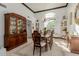 Elegant dining room featuring a wooden table, chandelier, and decorative built-in cabinets at 2438 N Forest Cir, Mesa, AZ 85203