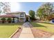 Inviting two-story home with lush green lawn, mature trees, and charming curb appeal at 2438 N Forest Cir, Mesa, AZ 85203