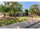 Two-story home with landscaped yard, mature trees, and a charming front porch at 2438 N Forest Cir, Mesa, AZ 85203