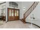 Grand foyer with tiled floors, staircase, and decorative chandelier at 2438 N Forest Cir, Mesa, AZ 85203