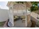The backyard features a quaint gazebo with cushioned seating and views of the property at 2438 N Forest Cir, Mesa, AZ 85203