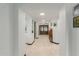 Bright hallway with tiled floors, arched doorways, and recessed lighting at 2438 N Forest Cir, Mesa, AZ 85203