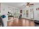 Bright home gym featuring hardwood floors, mirrored walls, exercise equipment, and a ceiling fan at 2438 N Forest Cir, Mesa, AZ 85203
