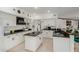 Well-lit kitchen featuring white cabinetry, granite countertops, and a functional island at 2438 N Forest Cir, Mesa, AZ 85203