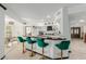 Bright kitchen featuring a breakfast bar with green stools and sleek countertops at 2438 N Forest Cir, Mesa, AZ 85203