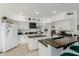 Modern kitchen with white cabinets, black countertops, and stainless steel appliances at 2438 N Forest Cir, Mesa, AZ 85203
