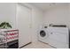 Laundry room with side-by-side washer and dryer and storage shelves at 2438 N Forest Cir, Mesa, AZ 85203