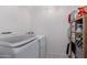 Bright laundry room with white washer and dryer set and organized shelving at 2438 N Forest Cir, Mesa, AZ 85203
