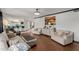 Open-concept living room flowing into the kitchen with breakfast bar seating at 2438 N Forest Cir, Mesa, AZ 85203