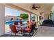 Covered outdoor patio with dining set overlooking a backyard pool and a gazebo at 2438 N Forest Cir, Mesa, AZ 85203