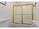 Bathroom with a shower featuring frosted glass doors and a gold frame at 2438 N Forest Cir, Mesa, AZ 85203