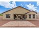 Rear exterior view of the home with a covered patio and gravel landscaping at 25212 W Maldonado Dr, Buckeye, AZ 85326