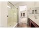 This bathroom boasts tile floors, a glass-enclosed shower, and convenient access to the main bedroom at 25212 W Maldonado Dr, Buckeye, AZ 85326