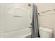 Clean bathroom with a white shower-tub combo and gray shower curtain at 25212 W Maldonado Dr, Buckeye, AZ 85326