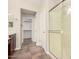 Modern bathroom showcasing tile flooring, a glass-enclosed shower, and access to a large walk-in closet at 25212 W Maldonado Dr, Buckeye, AZ 85326