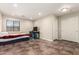 Large bonus room/bedroom with tile flooring, ceiling lights and window at 25212 W Maldonado Dr, Buckeye, AZ 85326