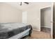 Bedroom with carpet and neutral walls, showcasing a view into an adjoining room with tile floor at 25212 W Maldonado Dr, Buckeye, AZ 85326