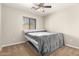Comfortable bedroom with neutral walls and carpet, and a window with blinds for natural light at 25212 W Maldonado Dr, Buckeye, AZ 85326