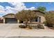 Charming single-story home featuring desert landscaping, a two-car garage, and an inviting facade on a sunny day at 25212 W Maldonado Dr, Buckeye, AZ 85326
