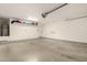 Spacious garage with epoxy flooring, bright lighting, and ample storage space at 25212 W Maldonado Dr, Buckeye, AZ 85326