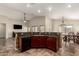 Open kitchen features dark cabinets and granite countertops and eat in island. The adjoining dining area is spacious at 25212 W Maldonado Dr, Buckeye, AZ 85326