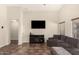 Spacious living room featuring high ceilings, neutral paint, tile floors, ceiling fan, and a large, comfortable sectional sofa at 25212 W Maldonado Dr, Buckeye, AZ 85326
