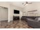 Spacious living room with high ceilings, neutral paint, tile floors, ceiling fan, and a large, comfortable sectional sofa at 25212 W Maldonado Dr, Buckeye, AZ 85326