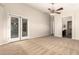 This is a spacious main bedroom with neutral carpet, a ceiling fan, and access to the en suite bathroom at 25212 W Maldonado Dr, Buckeye, AZ 85326
