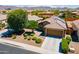 An aerial view of a home with solar panels, desert landscaping, and a tile roof at 26071 W Sequoia Dr, Buckeye, AZ 85396