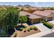 An aerial view of a well-landscaped home with a manicured lawn, tile roof and desert landscaping at 26071 W Sequoia Dr, Buckeye, AZ 85396