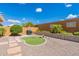 Beautiful backyard featuring a putting green, BBQ grill, and custom desert landscaping at 26071 W Sequoia Dr, Buckeye, AZ 85396