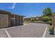 This backyard features a low-maintenance gravel area and partially screened patio for outdoor enjoyment at 26071 W Sequoia Dr, Buckeye, AZ 85396