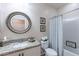 Bathroom featuring an oval mirror, granite countertop, and shower-tub combo at 26071 W Sequoia Dr, Buckeye, AZ 85396