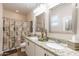 Bathroom features a double sink granite vanity and a shower with a shower curtain at 26071 W Sequoia Dr, Buckeye, AZ 85396