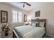 Cozy bedroom with natural light, comfortable bed, and tasteful decor with a ceiling fan at 26071 W Sequoia Dr, Buckeye, AZ 85396