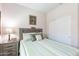 Cozy bedroom featuring a striped bedspread, wood headboard and an ample closet at 26071 W Sequoia Dr, Buckeye, AZ 85396