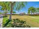 Community park featuring a green space with shade trees, picnic tables, and walking paths at 26071 W Sequoia Dr, Buckeye, AZ 85396