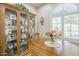 Dining nook with wood table, shuttered window, and curio cabinet at 26071 W Sequoia Dr, Buckeye, AZ 85396