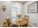 Dining nook area with round table set and large window with shutters at 26071 W Sequoia Dr, Buckeye, AZ 85396