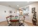 Dining room with glass table, carpet and tile flooring, open to living room and kitchen at 26071 W Sequoia Dr, Buckeye, AZ 85396