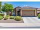Charming single-story home with stone accents, a well-maintained front yard, and a two-car garage at 26071 W Sequoia Dr, Buckeye, AZ 85396