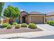 Charming single-story home with stone accents, a well-maintained front yard, and a two-car garage at 26071 W Sequoia Dr, Buckeye, AZ 85396