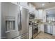 Kitchen with stainless steel appliances and white cabinets and drawers at 26071 W Sequoia Dr, Buckeye, AZ 85396