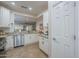 Bright kitchen featuring stainless steel appliances, white cabinets, and granite countertops at 26071 W Sequoia Dr, Buckeye, AZ 85396