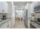 Open kitchen with white cabinets, granite countertops, stainless appliances and a dining nook at 26071 W Sequoia Dr, Buckeye, AZ 85396