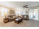 Spacious living room with comfortable seating, a ceiling fan, and access to an outdoor patio at 26071 W Sequoia Dr, Buckeye, AZ 85396